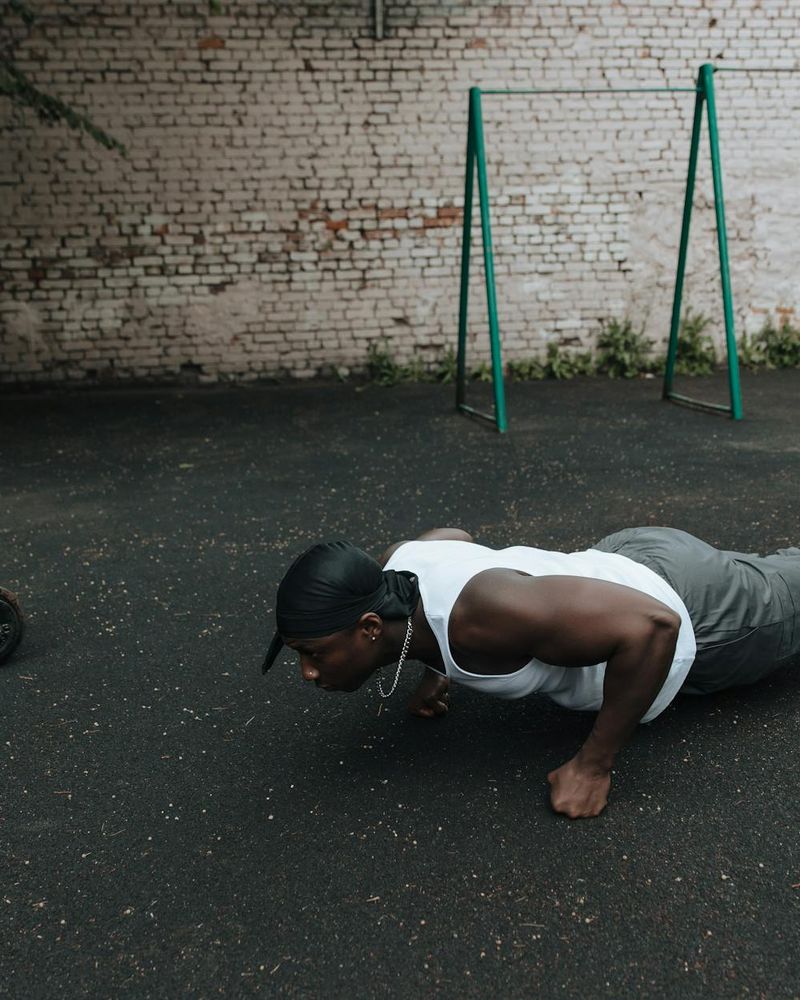 Strong man practicing bodyweight exercise in a dark atmosphere.